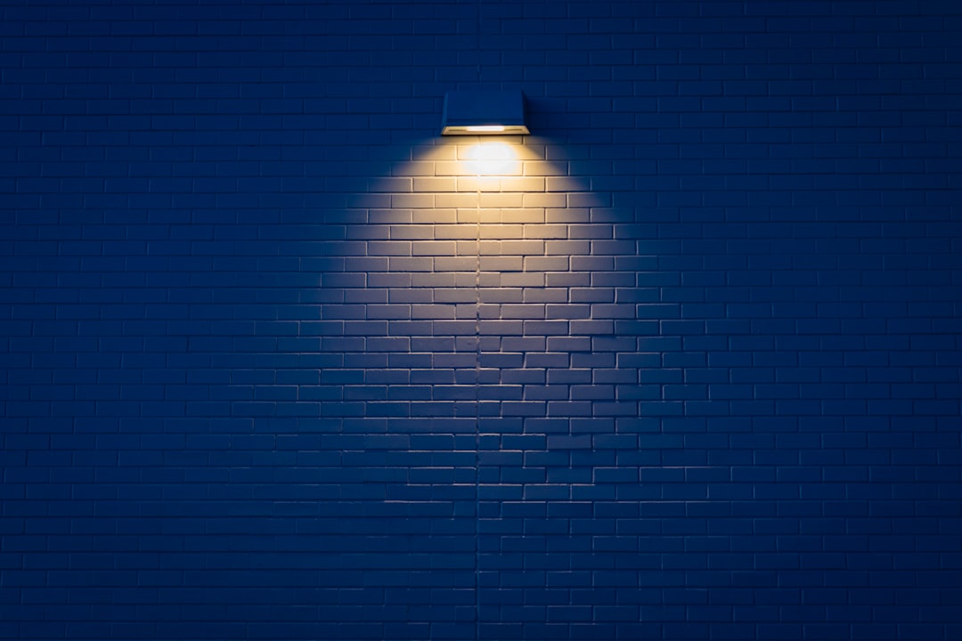 Glowing geometric light panels mounted on a dark wall